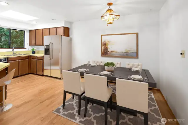 Virtually staged dining area next to the kitchen. Refrigerator is virtual.