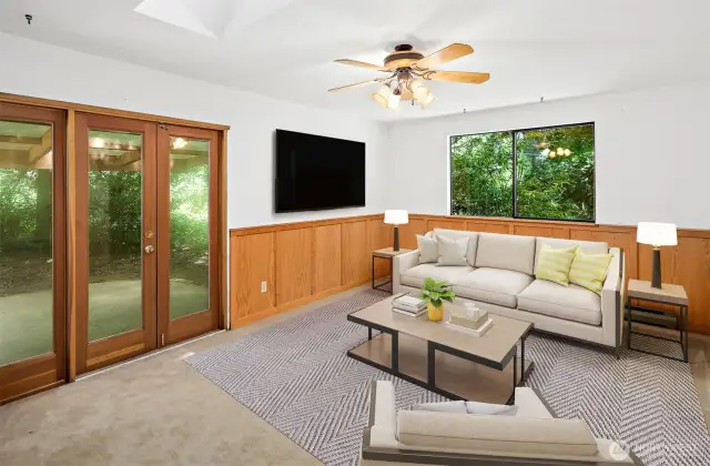 Virtually staged family room with double doors to  the back patio.