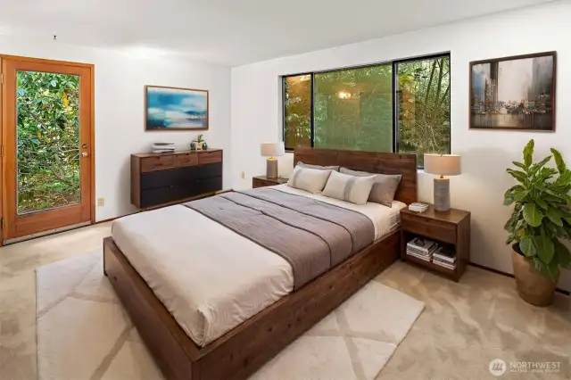 Virtually staged primary bedroom with separate side door entrance.