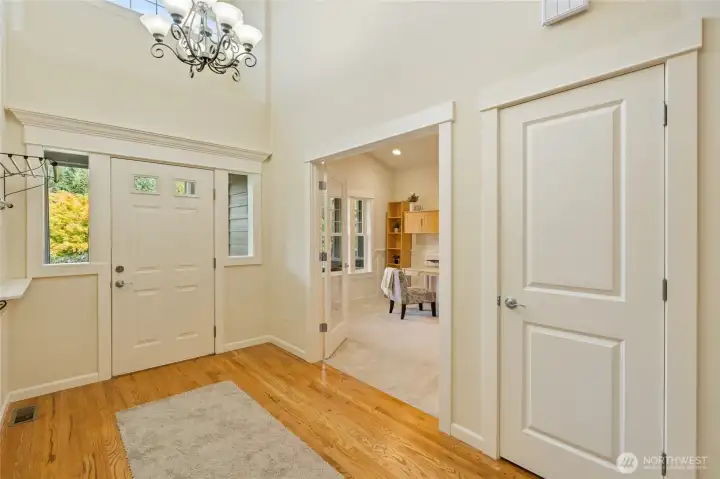 Vaulted ceiling with window above make entry way filled with light, coat storage as well.