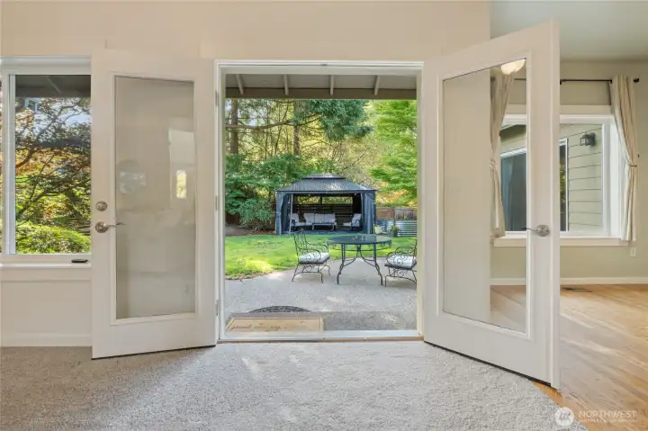 French doors lead to back yard with patio