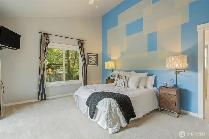 High ceilings create a dramatic primary suite