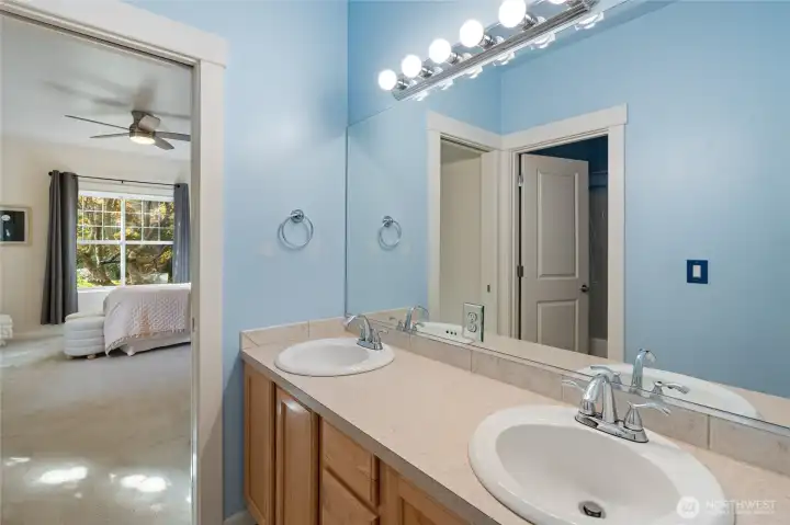 Jack and Jill bath with double sinks connects bedrooms 2 and 3