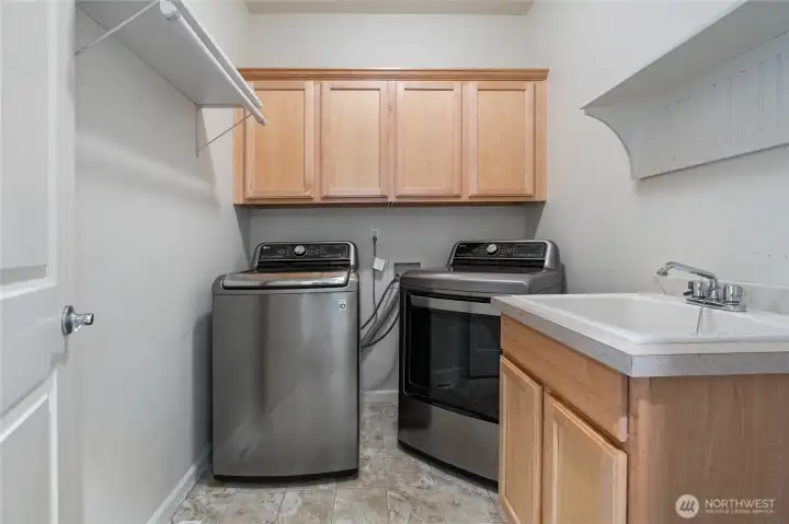 Laundry room with utility sink and storage