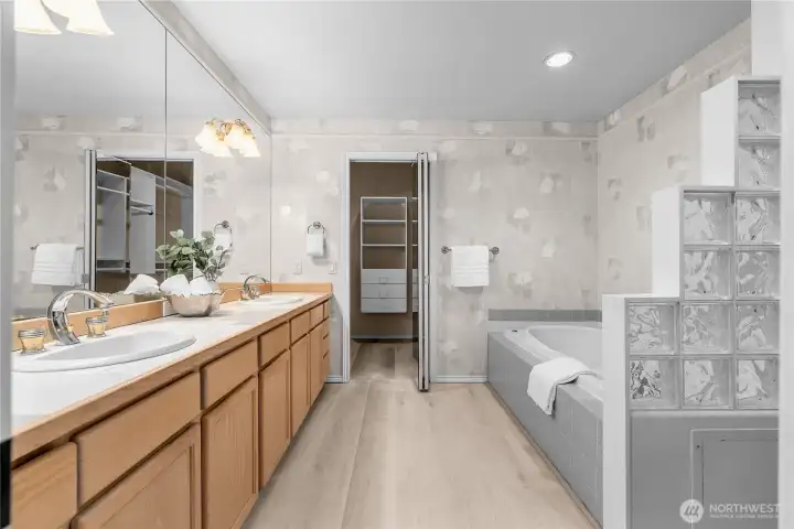 The en suite main bathroom is huge! Can you believe all these cabinets and counterspace?! Straight ahead is the walk-in-closet. Behind the photo is the water closet (separate toilet room).