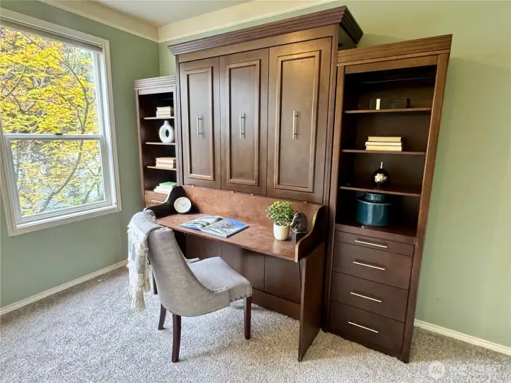 The murphy bed has a built-in desk, drawers, and shelves. When you fold down the bed you can leave items on the desk and they stay upright!