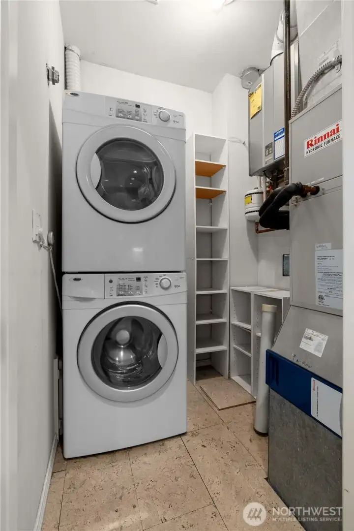 The utility room has in-unit laundry (washer & dryer included) and shows the on-demand tankless hot water heater and hydronic furnace.