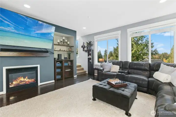 Living Room:  Bright, open, and welcoming—the living room is the heart of the home. Large windows frame peaceful views of the trees and valley beyond, while the cozy gas fireplace adds warmth and charm. Perfect for movie nights, quiet afternoons, or gathering with friends, this space truly brings comfort and connection together.