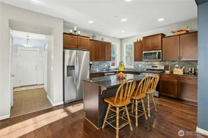 Kitchen:  A welcoming kitchen designed for both style and function. Granite counters, rich cabinetry, and stainless steel appliances blend seamlessly with the open layout. The spacious island offers plenty of prep space and casual seating, making this the perfect spot to gather and enjoy everyday moments.
