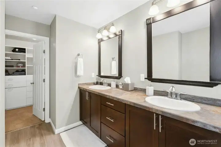 Primary Bathroom:  Beautifully updated and designed for comfort, this spa-inspired bathroom features dual vanities, modern fixtures, and warm finishes. The thoughtful layout connects seamlessly to a spacious walk-in closet, offering both style and convenience in one elegant space.
