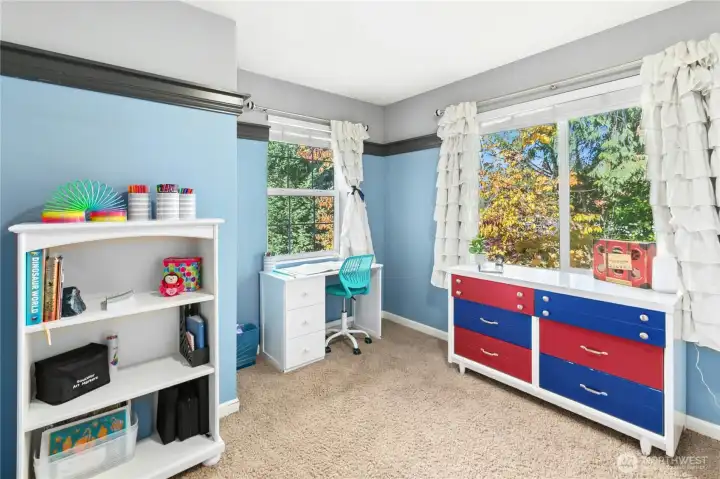 Bedroom Three (Alternate View):  Bright windows and a smart layout create the perfect spot for studying, reading, or relaxing. The cheerful tones make this room feel welcoming year-round.