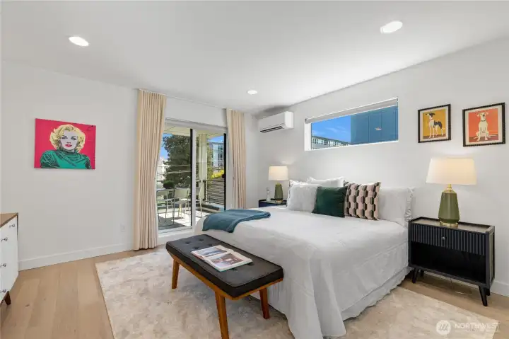 Spacious primary suite featuring a custom walk-in closet, a large covered deck, and a luxurious en-suite bathroom.