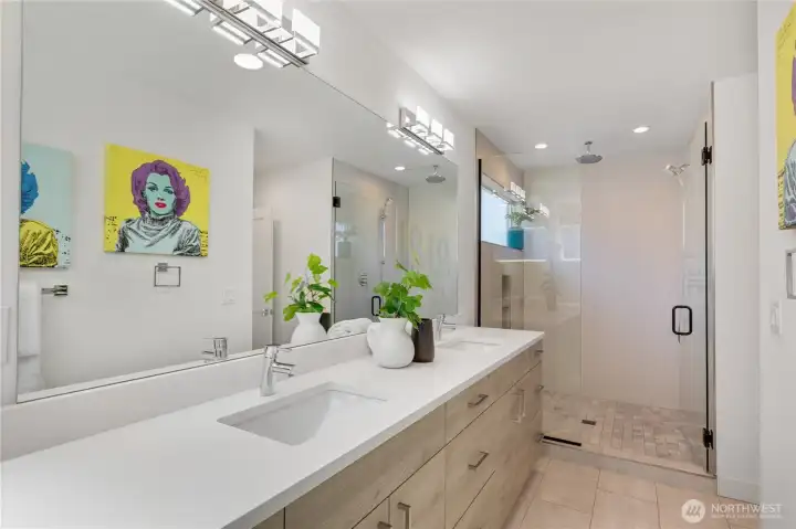 Primary bathroom featuring a double vanity and an oversized walk-in shower.