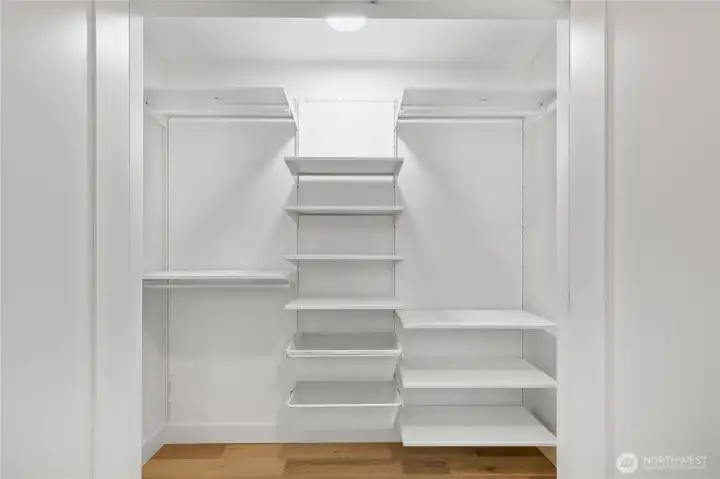 One of two spacious closets on the lower level - this one featuring custom built-in shelving.