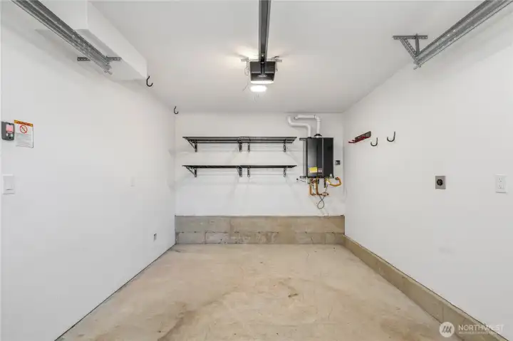 Attached full-size garage with storage shelving.