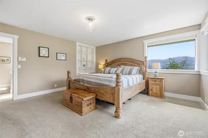 Roomy primary suit offers huge windows, Juliet balcony and built-in stylized bookcase.