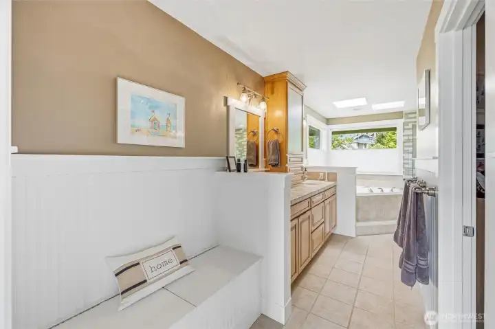 Primary bath has double sinks, soaking tub, tile shower, water closet, and huge walk-in closet