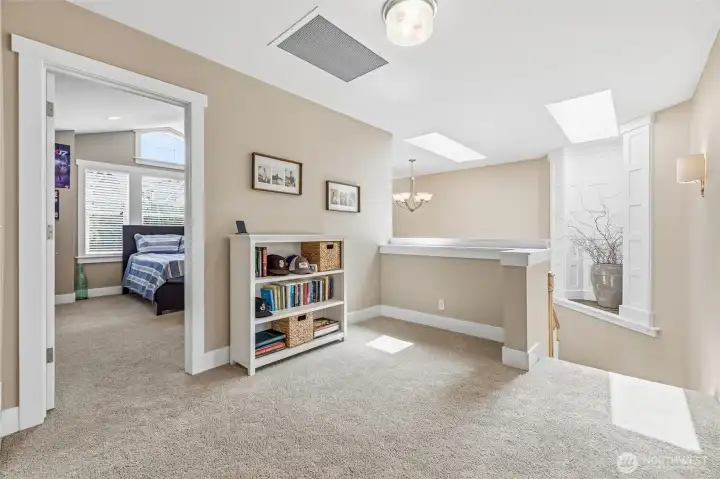 Upper landing featuring artful craftsmanship & skylight