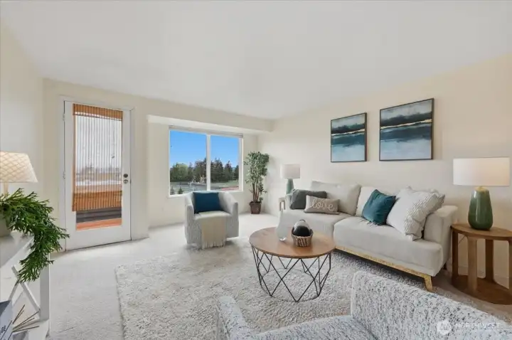 Large living room taking advantage of being Top Floor with endless sky view!  You should see the sunsets!  Partial views of Puget Sound as well & NO neighboring buildings means NO neighbors looking in.