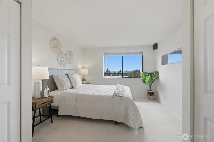 Primary bedroom offers double closets, room to move around and your own private vanity area - keeping your hall bath nice & tidy!  Sunsets gleam from this window as well!