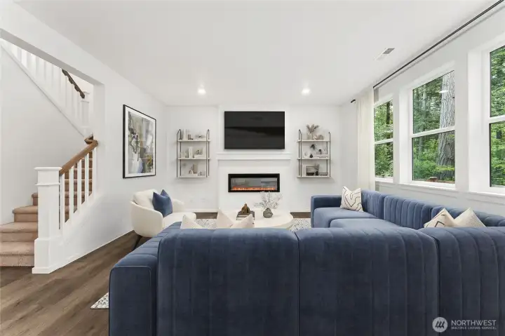 Cozy electric fireplace, open stair railing, and windows to open the space even more. Virtually Staged. Cozy electric fireplace, open stair railing, and windows to open the space even more. Virtually Staged.
