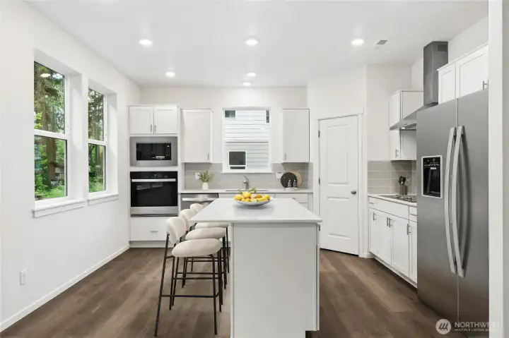 Large quartz countertop island. Soft close cabinets. Virtually Staged. Large quartz countertop island. Soft close cabinets. Virtually Staged.
