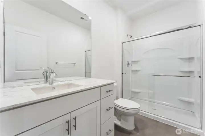 Downstairs bathroom features a walk-in shower. Downstairs bathroom features a walk-in shower.