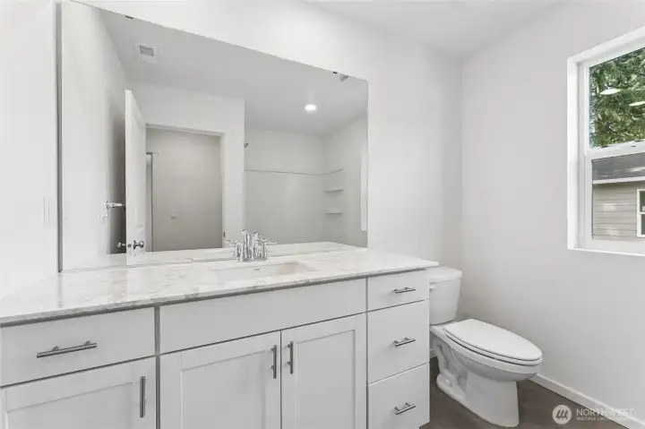 Upstairs bathroom with large quartz countertop, cabinet pulls, & soft close cabinets. Upstairs bathroom with large quartz countertop, cabinet pulls, & soft close cabinets.