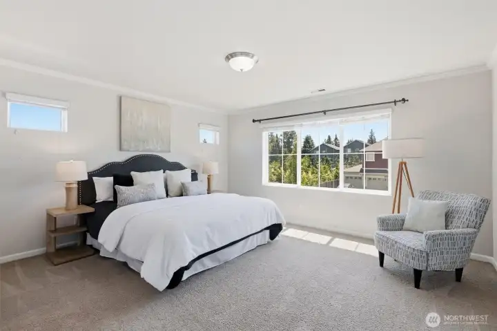 large primary suite with lots of natural light