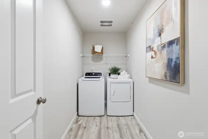 Utility room with washer and dryer on upper floor