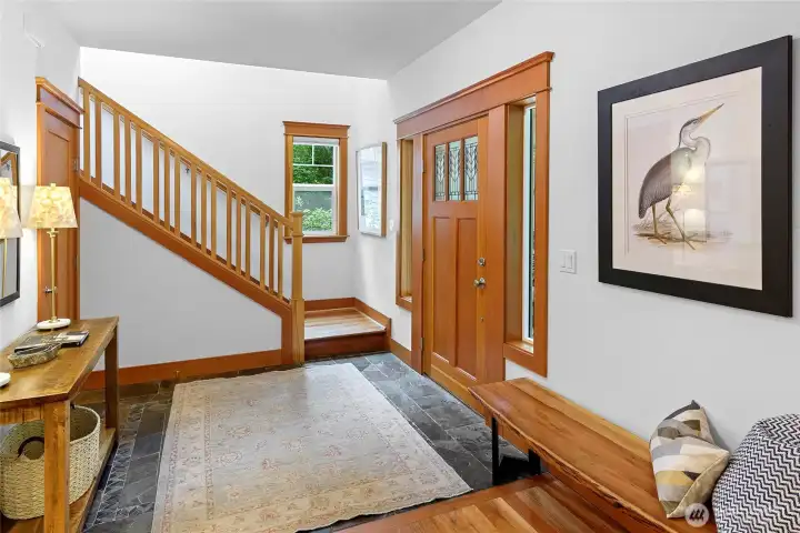 Warm entry with beautiful slate flooring and a well placed coat closet
