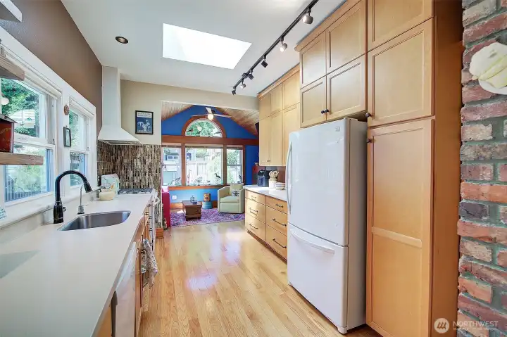 Kitchen with lovely tile work, oak flooring and plenty of cabinets. Kitchen with lovely tile work, oak flooring and plenty of cabinets.