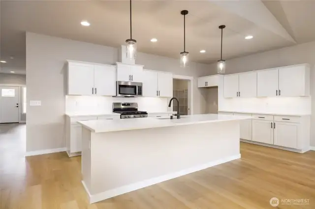 There is a large serving counter next to the walk-in pantry.