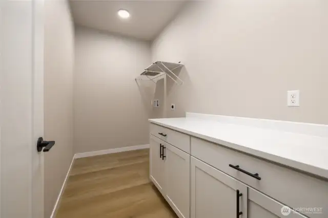 Utility room with counters for folding clothes.