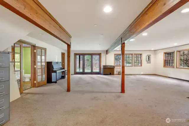 The Great room with doors that open to  front yard and guest half bathroom shown.