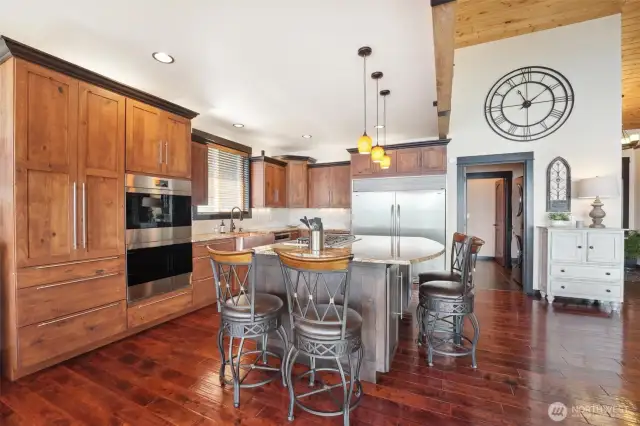 High end appliances include Wolf double ovens and Wolf stove top.  Don’t miss the gorgeous, hammered copper farm sink.