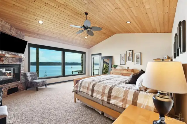 Wake up to the view in the large primary bedroom complete with fireplace and access to the patio.