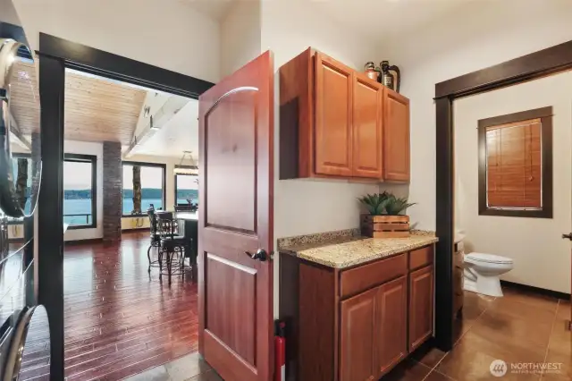 Butler’s pantry with prep space, storage, wine fridge and washer and dryer.