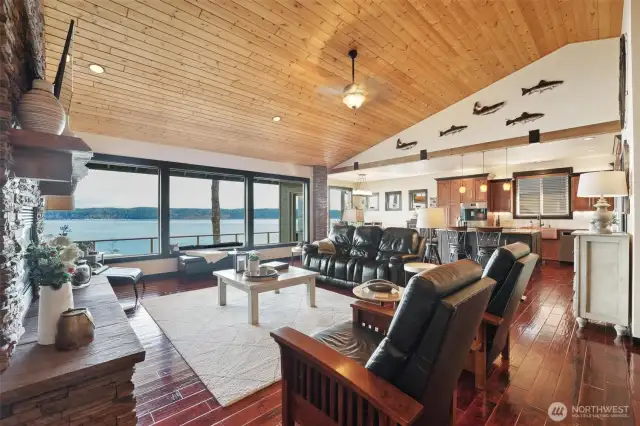 Check out all the attention to detail in the open concept great room. Including the floor to ceiling stone fireplace, wooden beams, vaulted ceilings and stone columns.