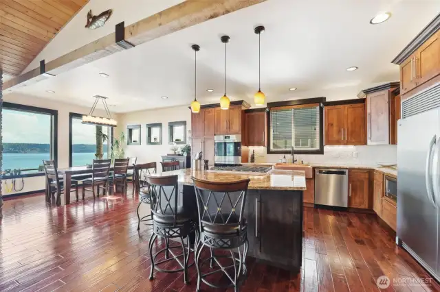 The great room opens to the spacious kitchen with high-end appliances and dining room with access to the incredible patio.