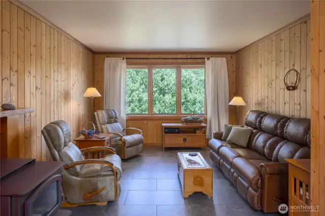 Living room has tile floors and wood heat.