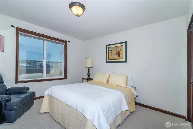 2nd bedroom with sun blocking film on the windows to keep the room cool