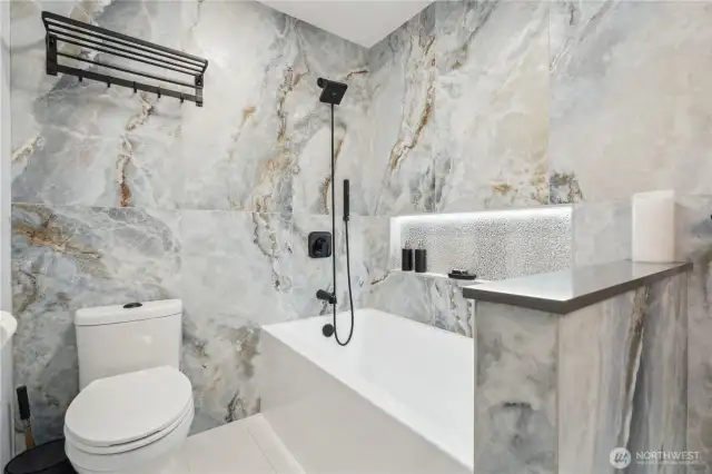 Luxurious upgrades to the main bath. Heated tile flooring, deep soaking tub, some niches and special lighting create a spa feel.