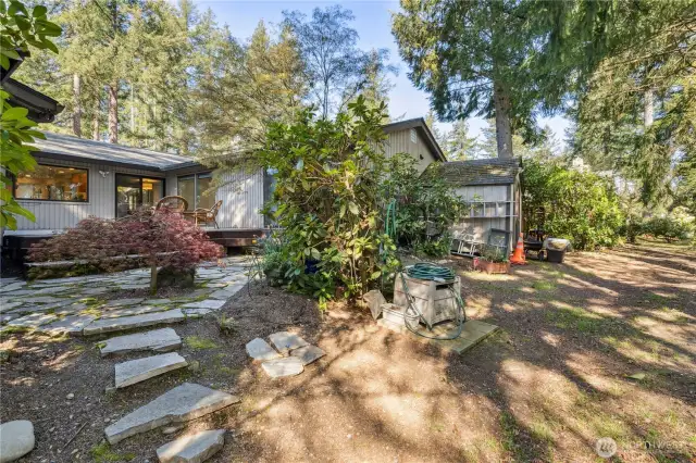 Flagstone steps to backyard area. Large shed structure is owned by the HOA and monitored by President Doug Gibbs.