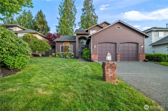 Beautifully maintained home with striking curb appeal, mature landscaping, and a welcoming covered entry. Quiet street with a level driveway and manicured lawn.