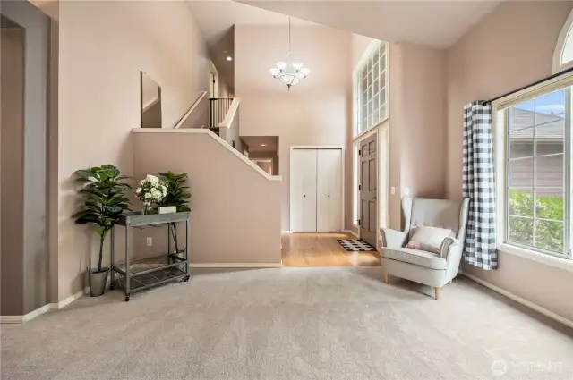 Grand entry with soaring ceilings, natural light, and a stylish two-tone wall palette creates a warm and elegant welcome.