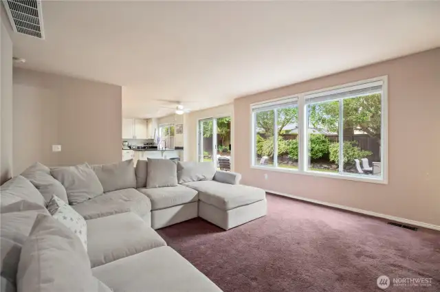 Spacious and light-filled family room opens directly to the kitchen and patio—great for indoor/outdoor entertaining.