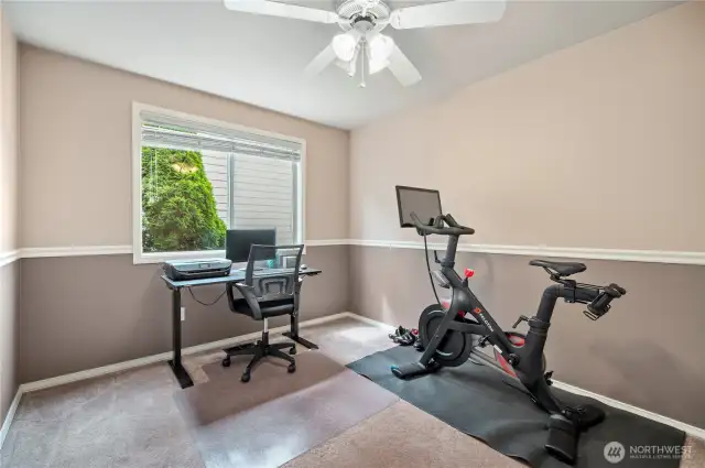 Versatile room with large window and ceiling fan—works great as a study, fitness room, or guest bedroom.