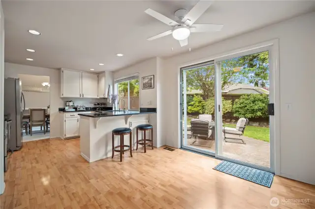 Light-filled kitchen opens to the backyard through a large sliding glass door—perfect for summer BBQs or morning coffee outdoors.