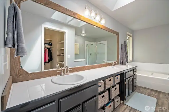 Oversized mirror, twin sinks, and updated fixtures provide everyday convenience.